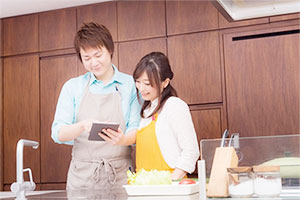 キッチンで仲良く並ぶ新婚夫婦